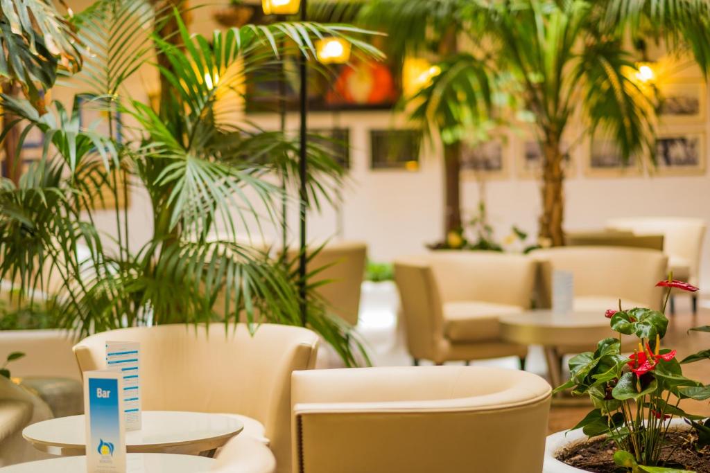 a restaurant with tables and chairs and umbrellas at Hotel Monopol in Puerto de la Cruz