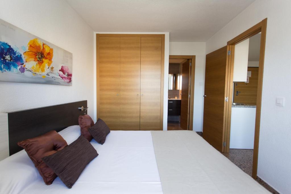 a bedroom with a large white bed in a room at Pio XII Apartments Valencia in Valencia
