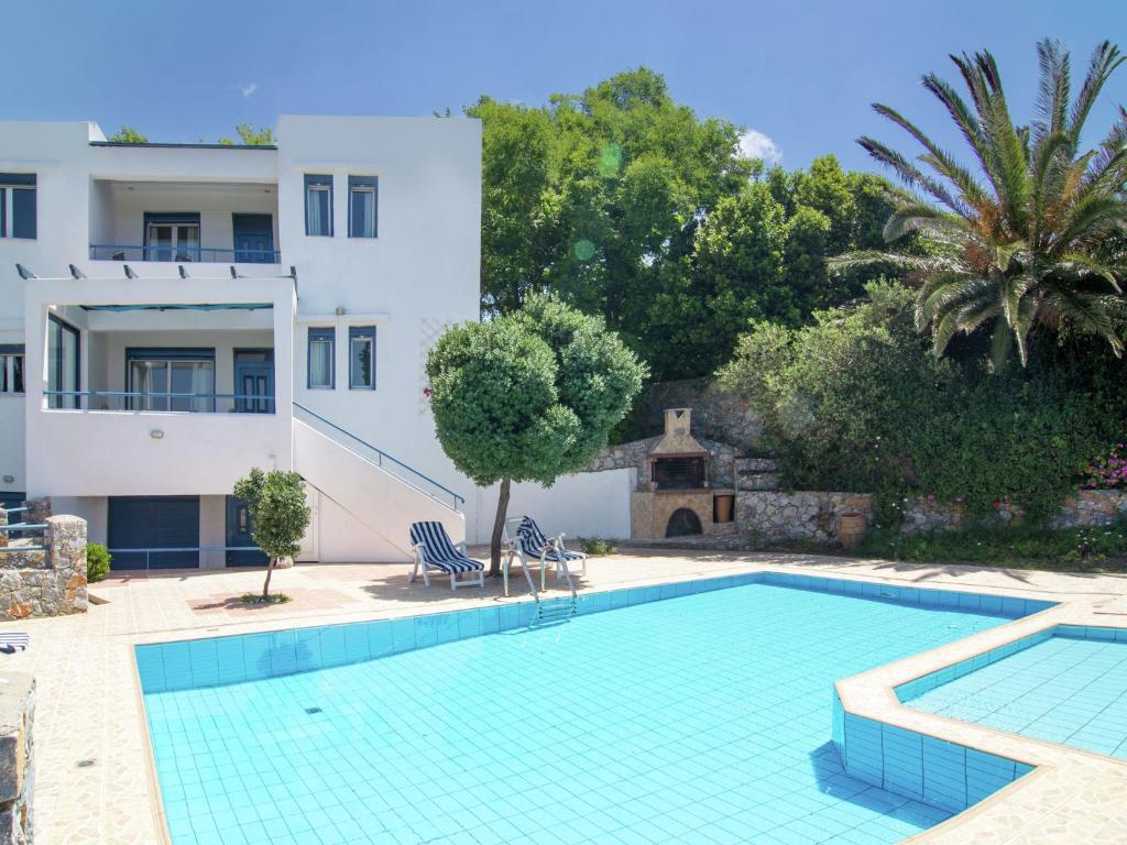 a swimming pool in front of a villa at Modish Villa in Lefkogia Crete with Swimming Pool in Lefkogeia