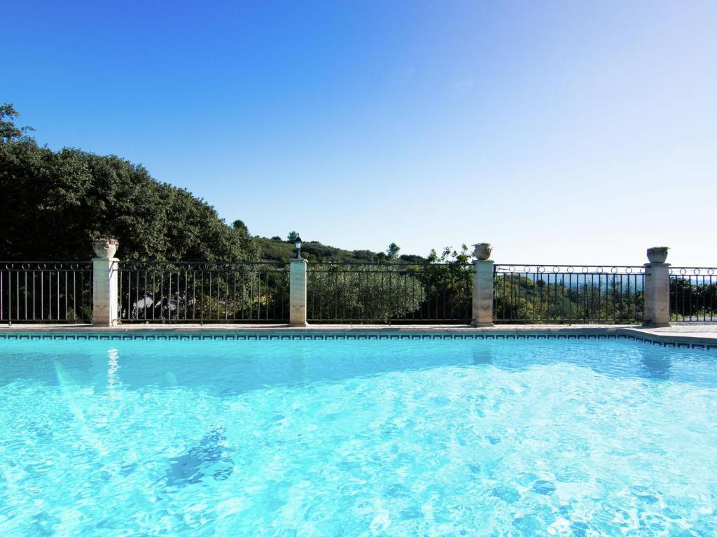 LédenonにあるModern Villa with Private Swimming Pool in L denonのフェンス前の青い水のスイミングプール