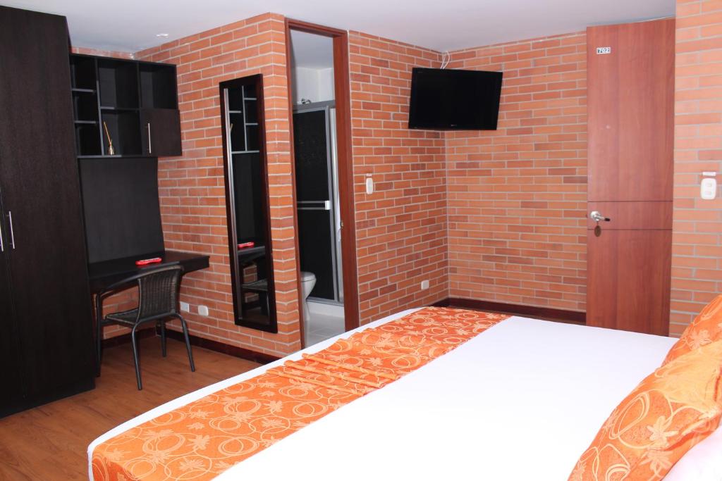 Postel nebo postele na pokoji v ubytování Hotel Bogota Astral