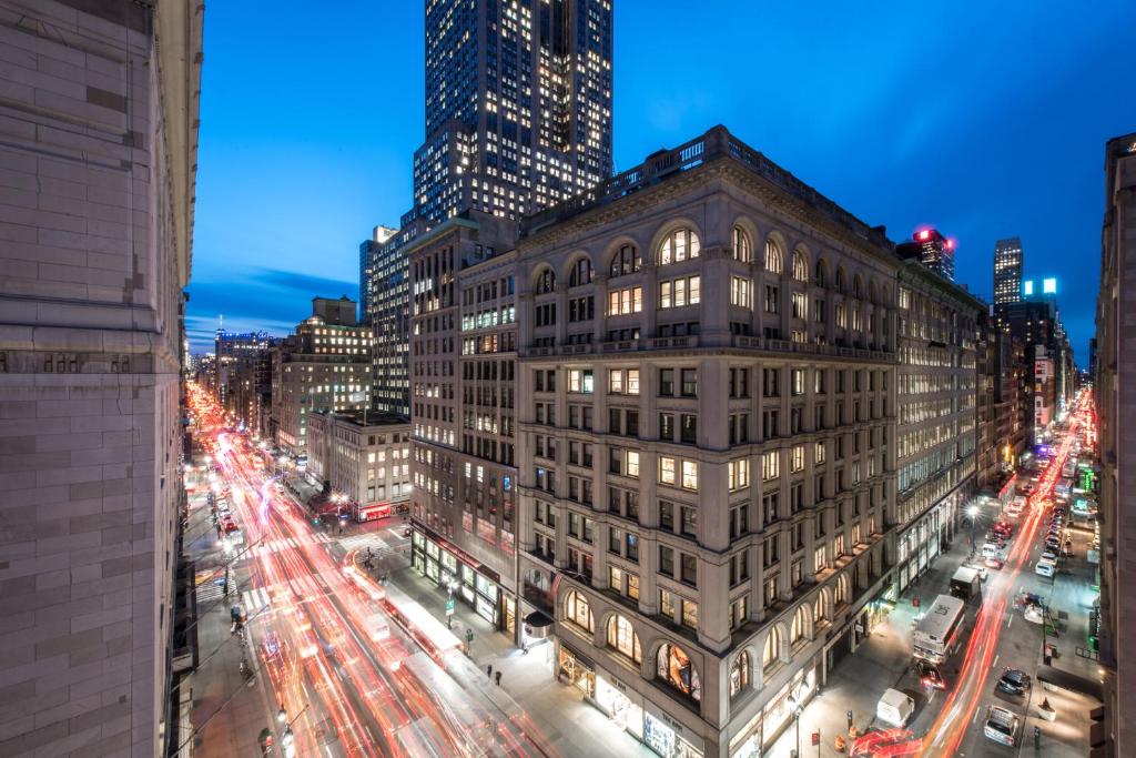 a view of a building in a city at night at U Hotel Fifth Avenue, Empire State Building in New York