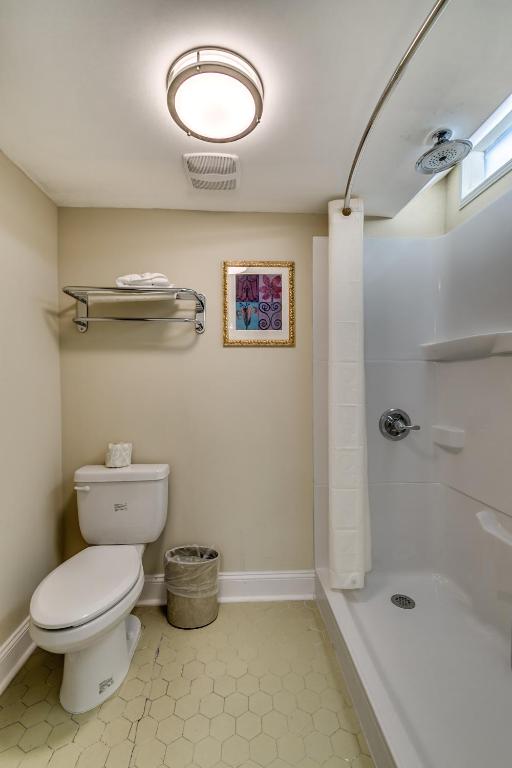 a bathroom with a white toilet and a shower at Beachcomber Inn & Suites in Myrtle Beach