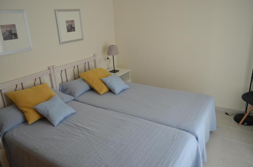 Posteľ alebo postele v izbe v ubytovaní Apartamentos Macenas