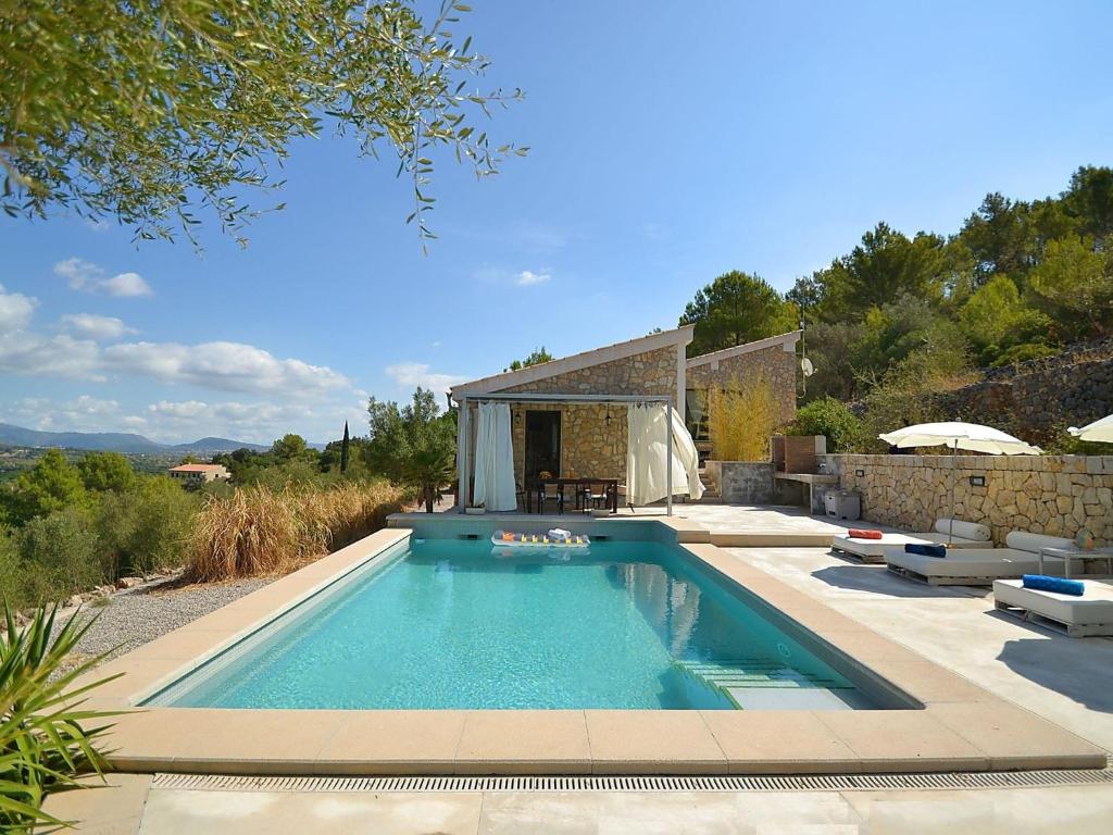 a swimming pool in front of a house at Belvilla by OYO Puigferrer in El Port de la Selva