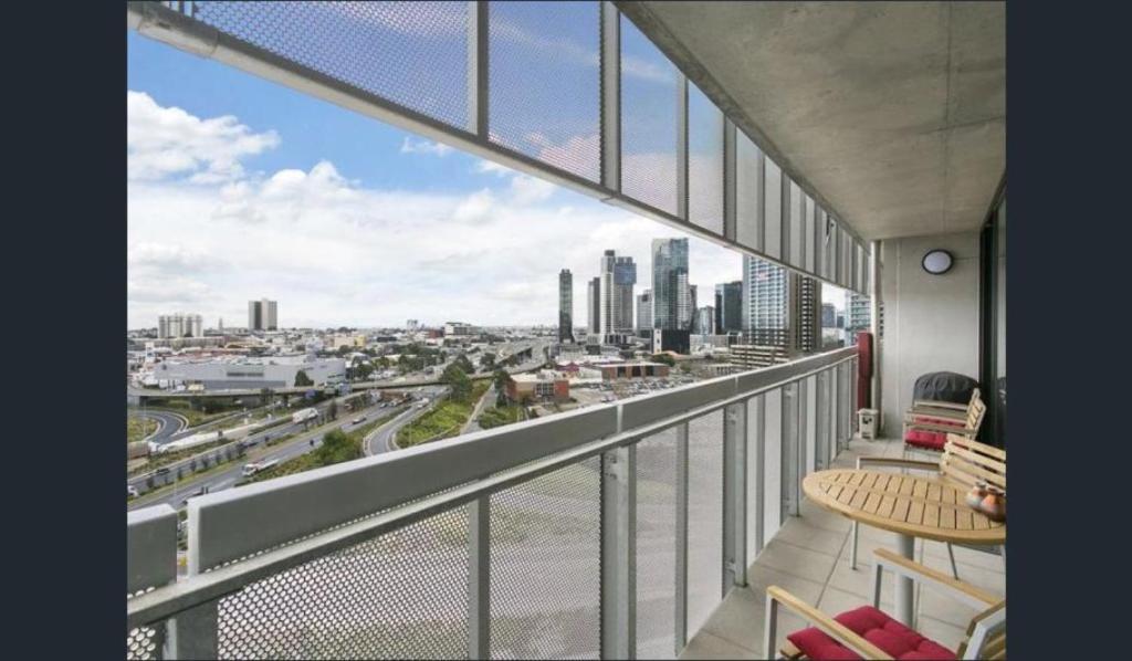 a balcony with a view of a city at StayCentral - NGV Arts Centre Retreat Southbank in Melbourne