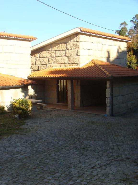 a stone building with a patio in front of it at Quinta do Grilo in Vieira do Minho