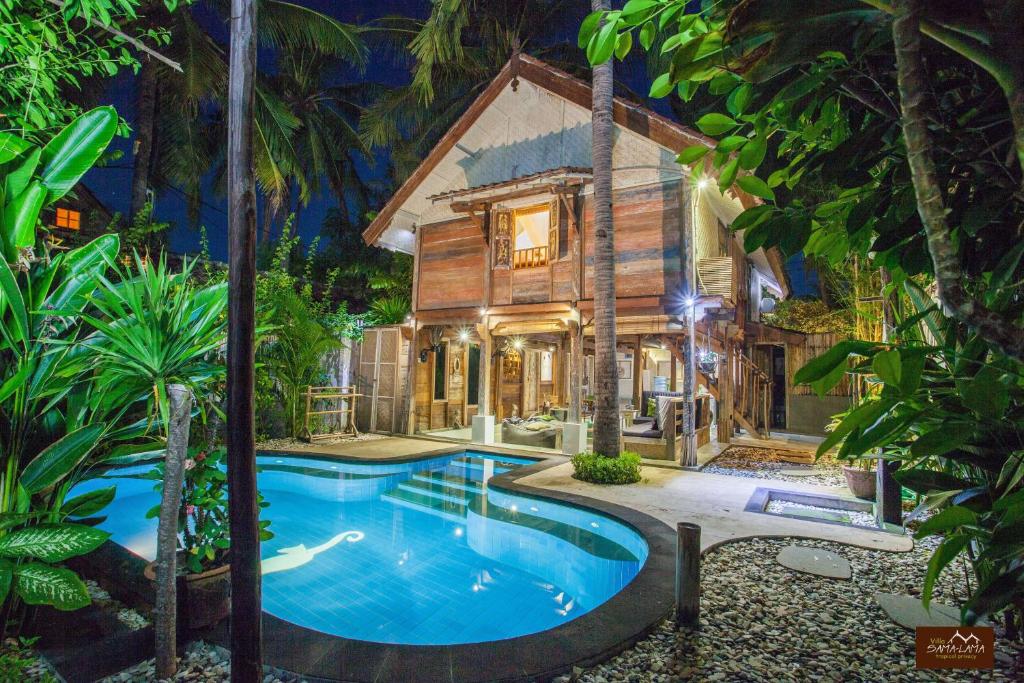 a home with a swimming pool in front of a house at Villas SAMALAMA Gili Trawangan in Gili Trawangan