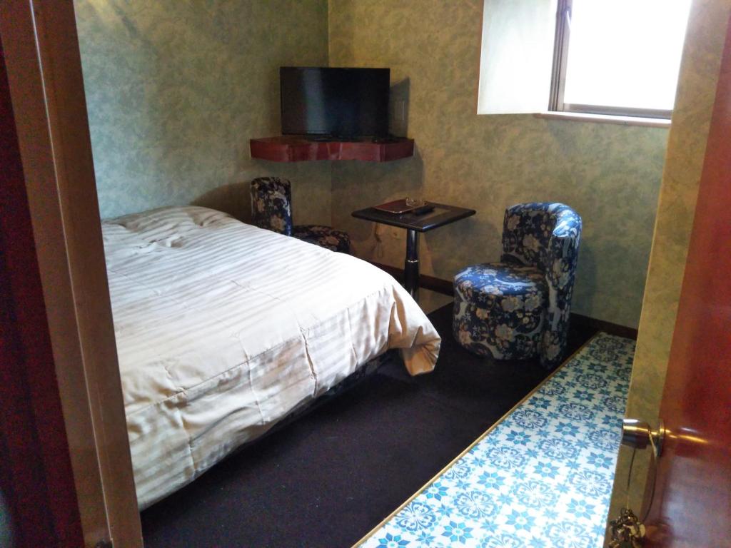 Postel nebo postele na pokoji v ubytování Hotel Unicorn