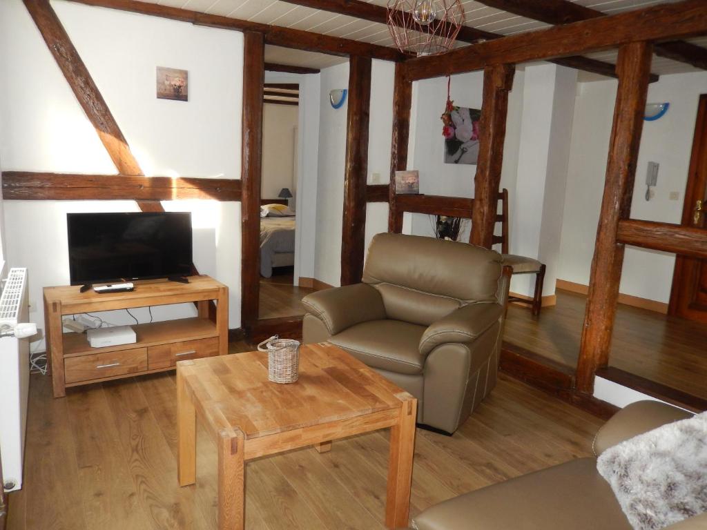 a living room with a couch and a chair and a table at Gîte Pinot in Beblenheim