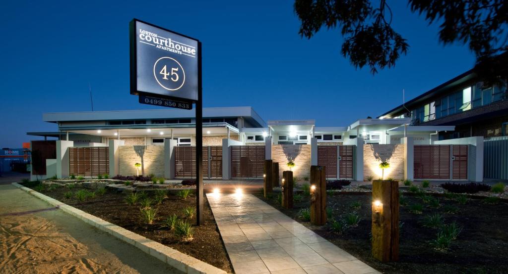 a street sign in front of a building at night at Loxton Courthouse Apartments in Loxton