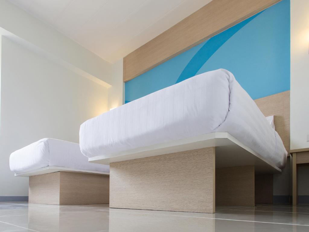 Letto o letti in una camera di HOP INN Chiang Rai