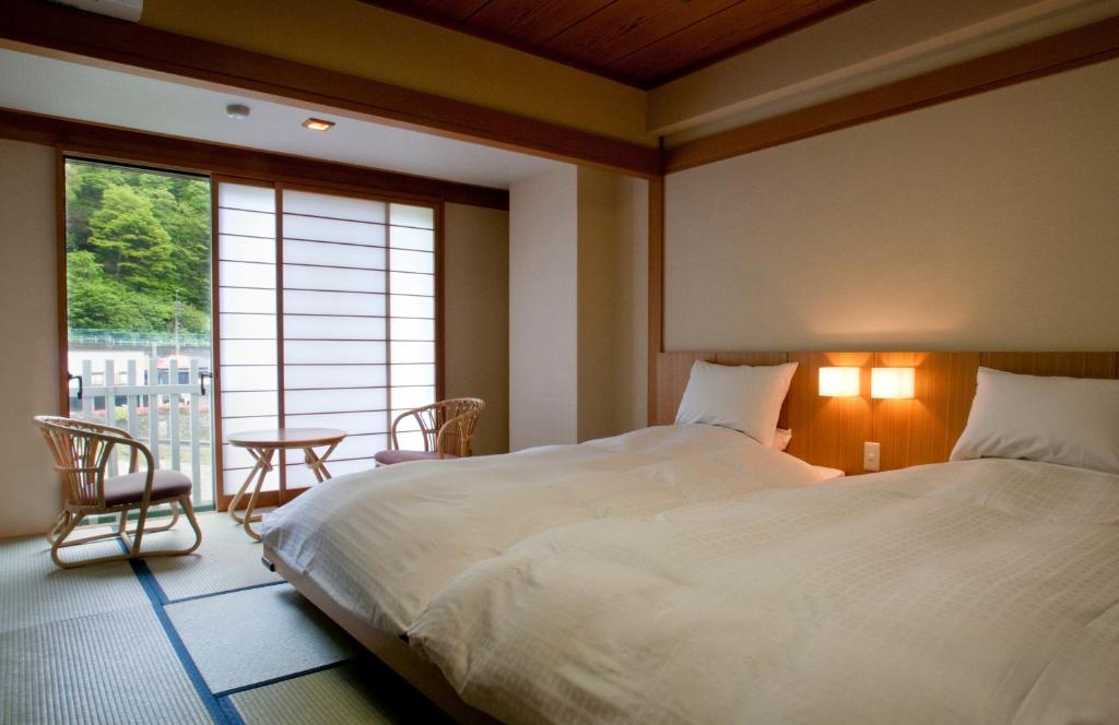 Postel nebo postele na pokoji v ubytování Kinugawa Onsen Hotel