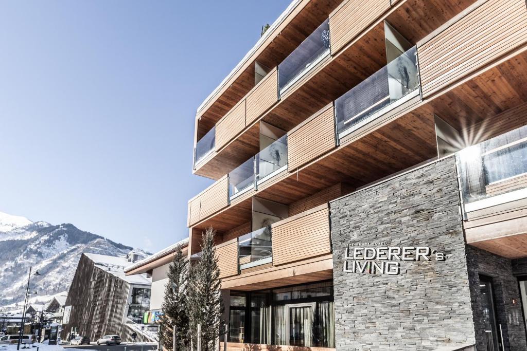 a building with a sign on the side of it at LEDERER Boutique Hotel in Kaprun