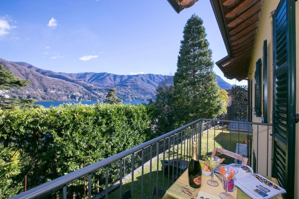 a balcony with a table and a view of the mountains at Residenza Regina in Laglio