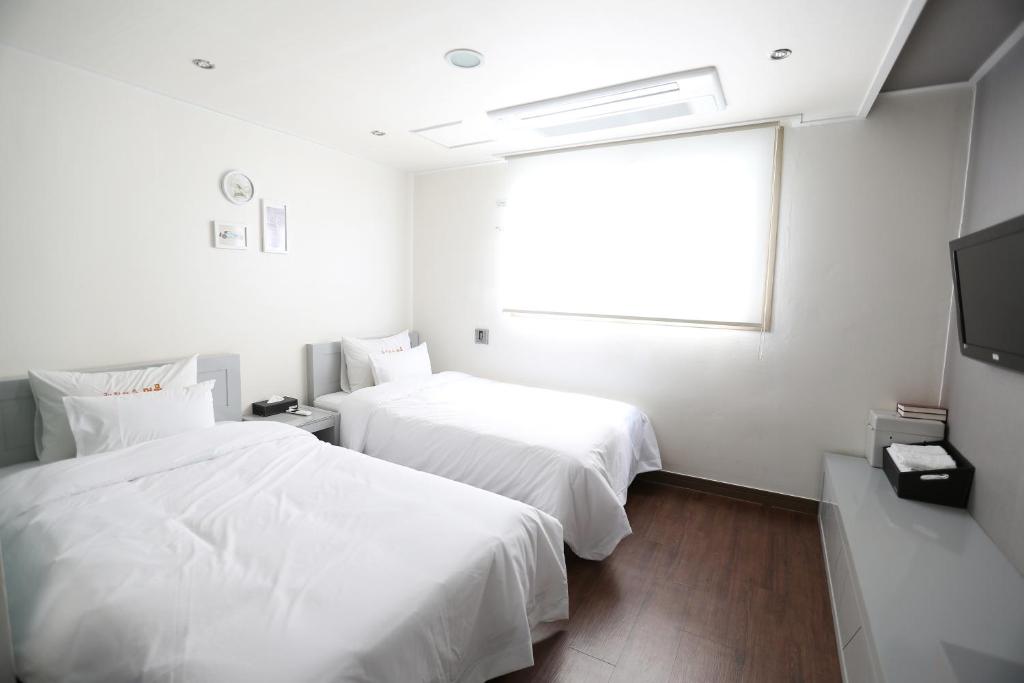Postel nebo postele na pokoji v ubytování Residence Mumum Hotel