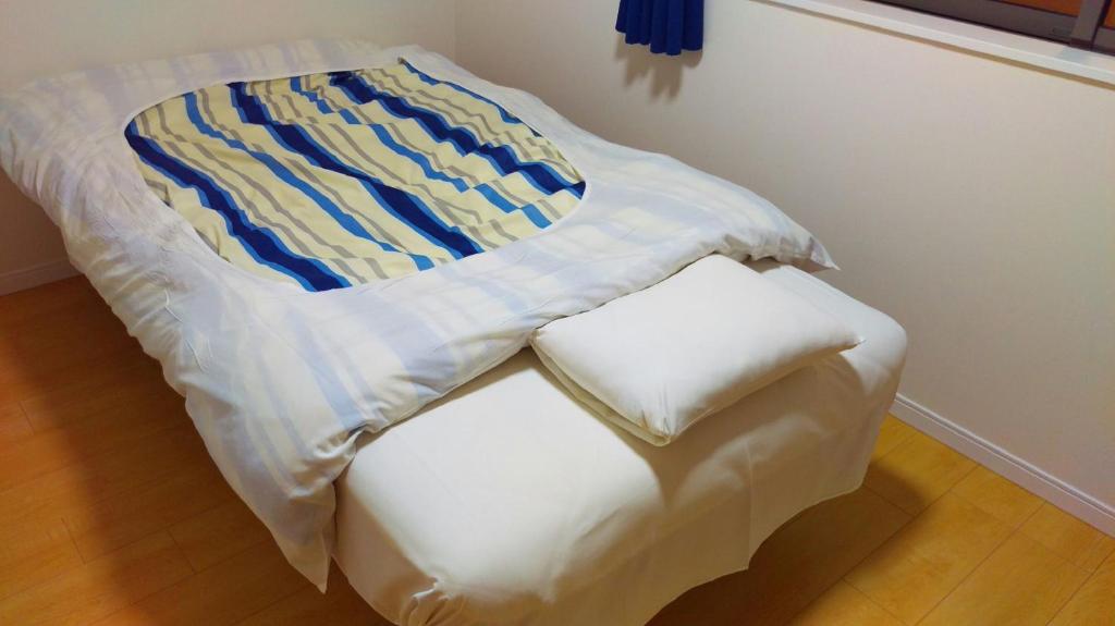 Postel nebo postele na pokoji v ubytování Uchi Matsushima Guesthouse