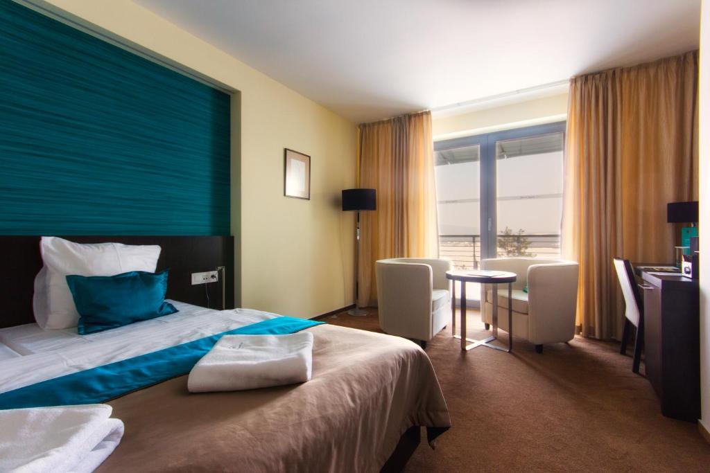 Postel nebo postele na pokoji v ubytování Hotel Zelená Lagúna