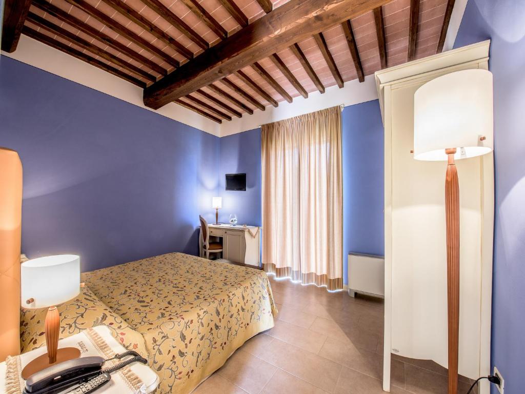 A bed or beds in a room at Albergo La Foresteria