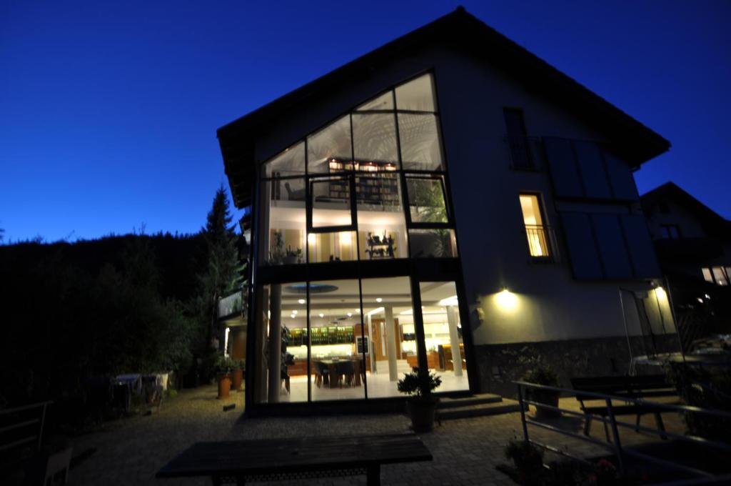 a large building with glass windows at night at Jaśminowe Ogrody in Szczyrk