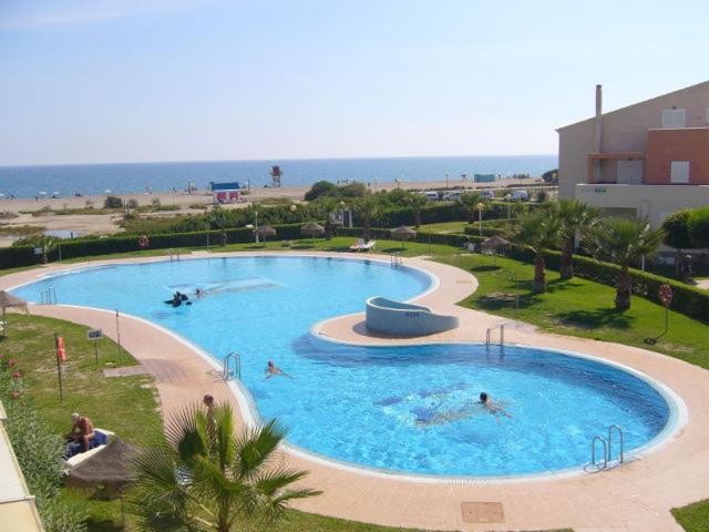 a group of people swimming in a pool at a resort at Vera Natura Urbanización Naturista in Vera
