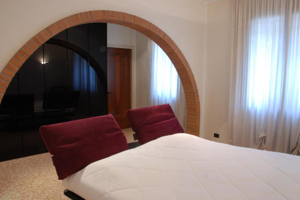 een slaapkamer met een groot bed en een spiegel bij Locazione Turistica Gioia in Padua