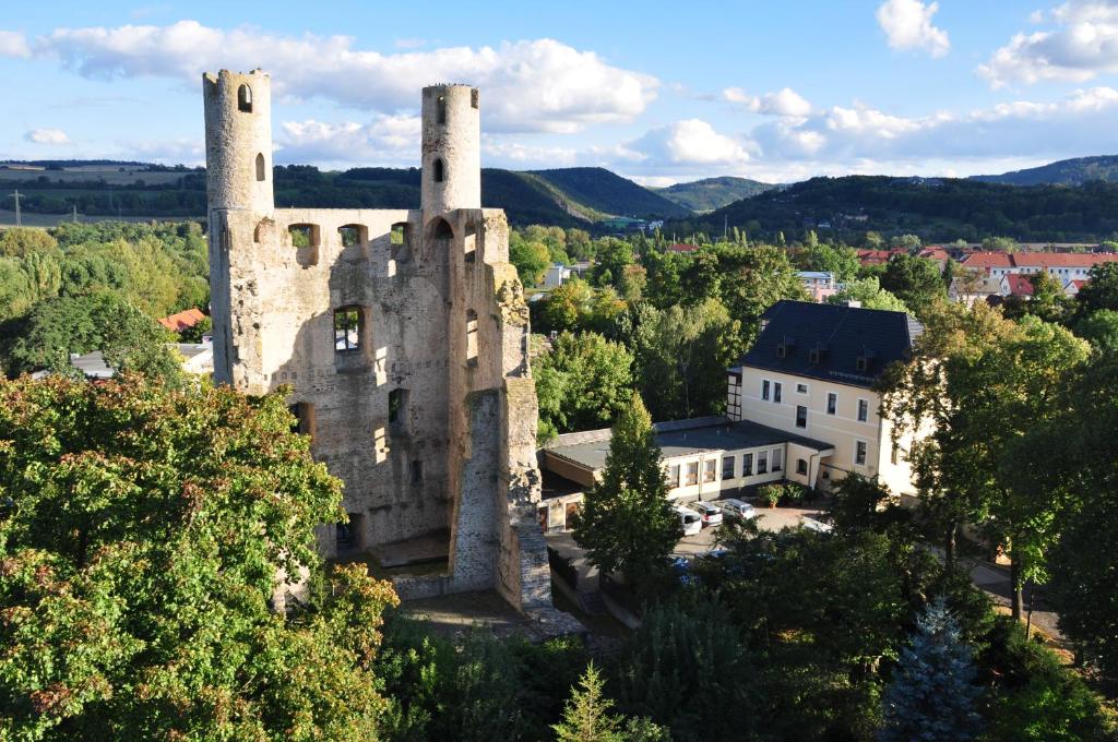 an old castle with two towers on top of it at Hotel Am Hohen Schwarm in Saalfeld
