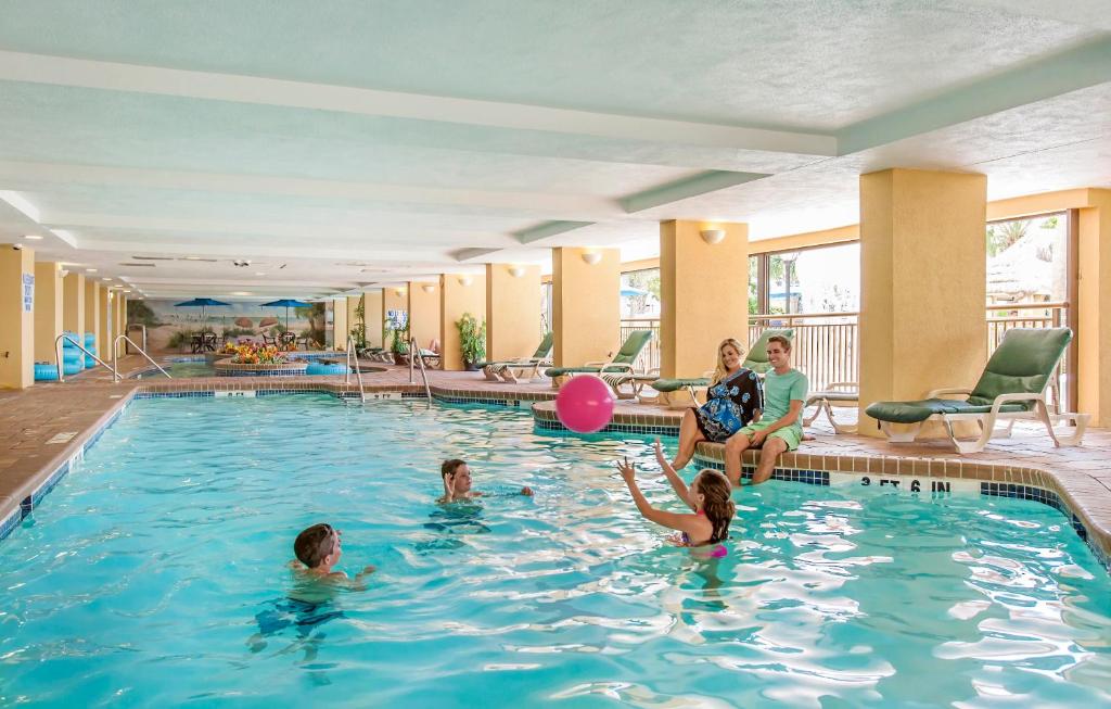 a group of children playing in a swimming pool at Holiday Pavilion Resort on the Boardwalk in Myrtle Beach