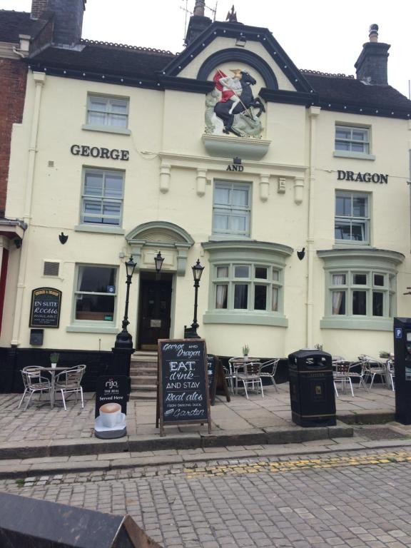 a white building with a sign in front of it at George and Dragon Ashbourne in Ashbourne