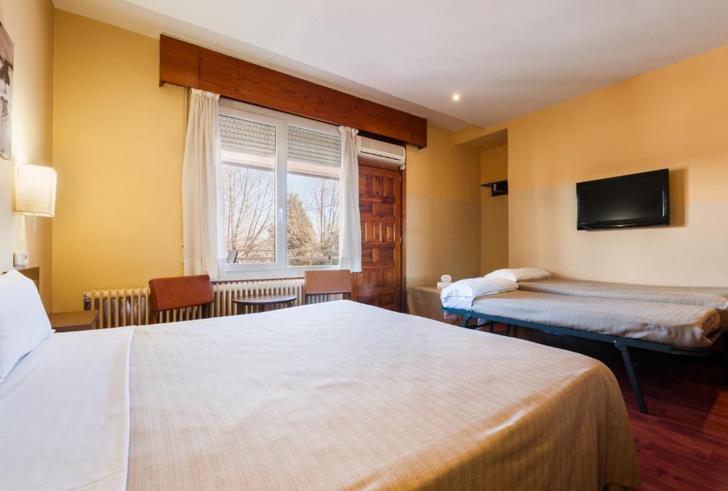 Postel nebo postele na pokoji v ubytování Hotel Los Olivos