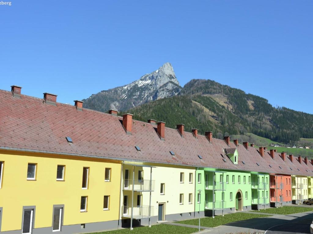 a row of buildings with a mountain in the background at Heritage Apartment in Eisenerz near Ski Area in Eisenerz