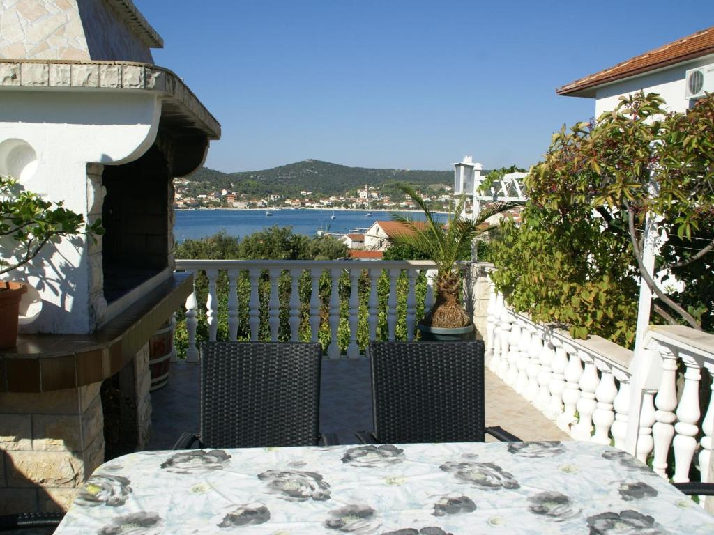 a table and chairs on a balcony with a view of the water at Neat apartment in Vinisce with magnificent sea and beach within walking distance in Vinišće