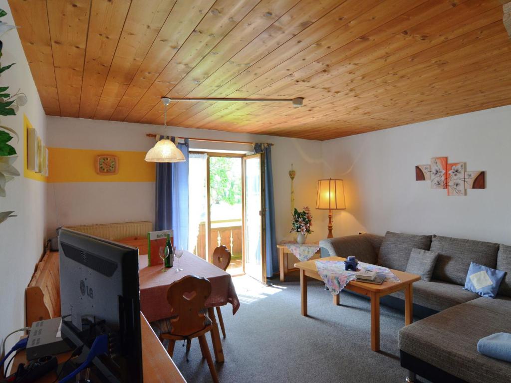 a living room with a couch and a table at Ferienwohnung in Bad Bayersoien in Bad Bayersoien