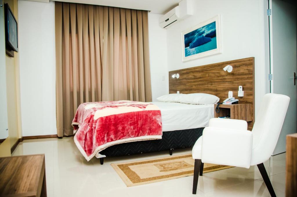 Schlafzimmer mit einem Bett, einem Schreibtisch und einem Stuhl in der Unterkunft Hotel Palace Frederico in Frederico Westphalen