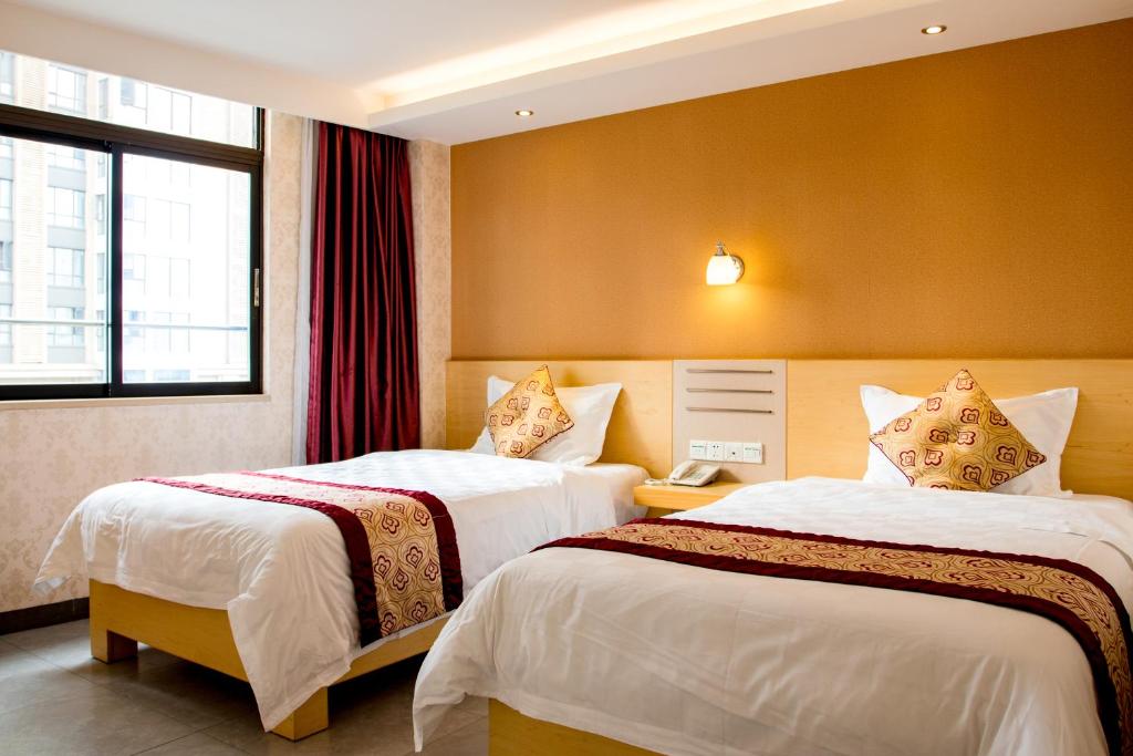 Postel nebo postele na pokoji v ubytování Guang Dong Hotel