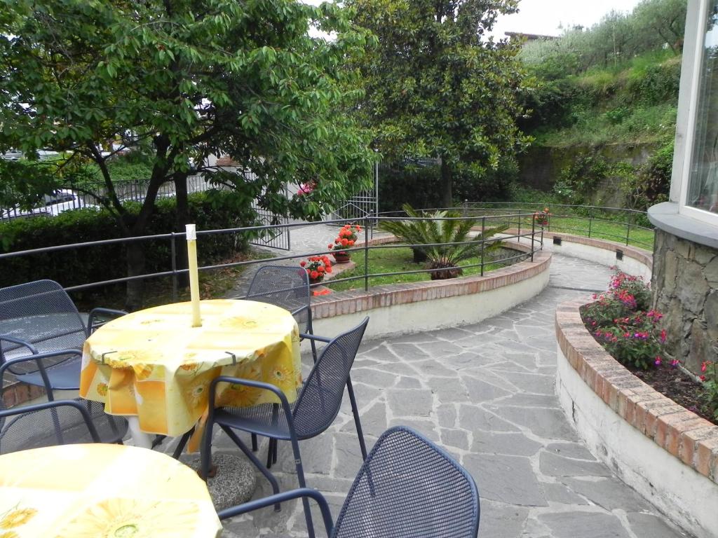 a table with a yellow table cloth on a patio at Hotel Il Saraceno in Volastra