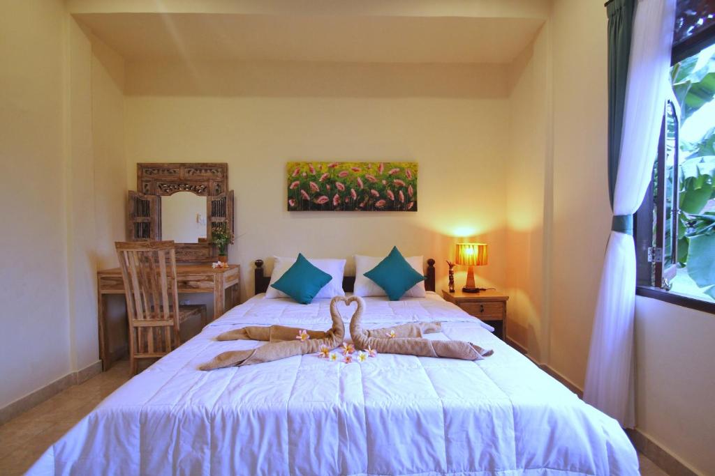 Postel nebo postele na pokoji v ubytování Pondok Muwa Guest House