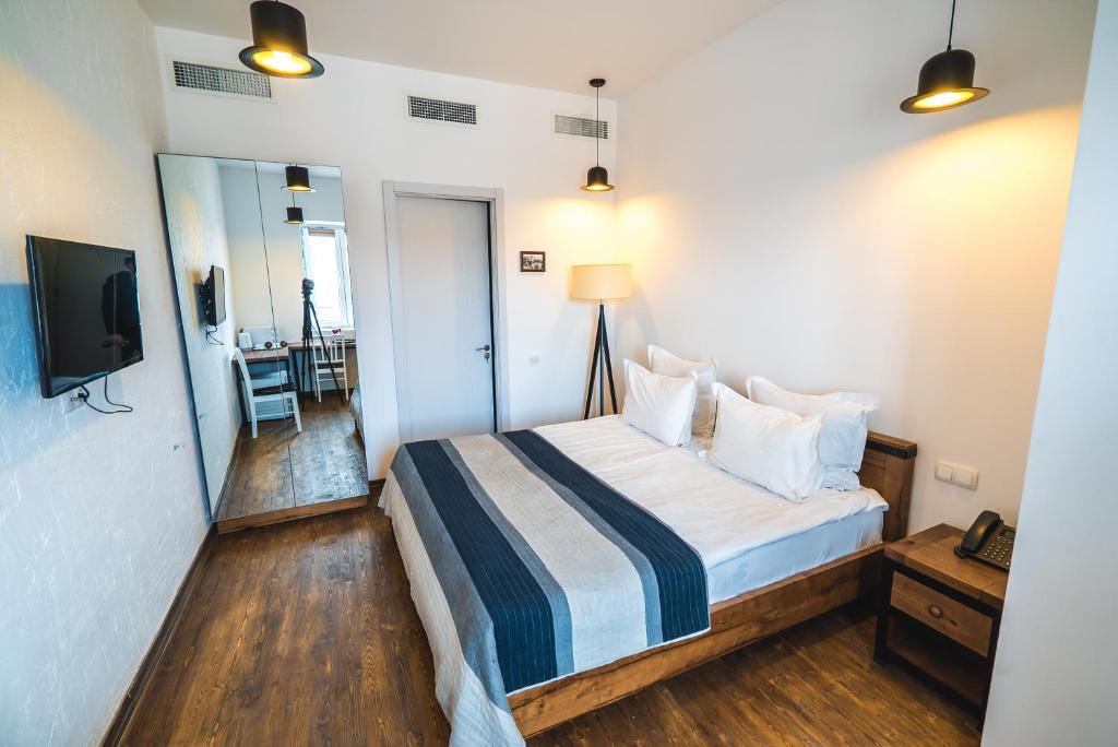 a hotel room with a bed and a television at Citadel Express in Tbilisi City