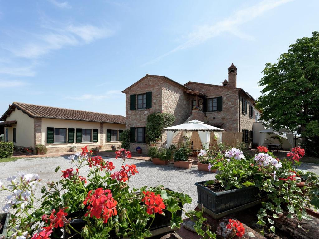 una casa con un mazzo di fiori davanti di Scenic Home in Foiano della Chiana with Terrace a Foiano della Chiana