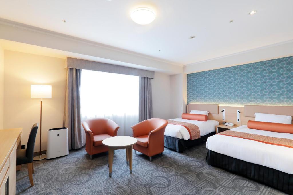 Postel nebo postele na pokoji v ubytování Sapporo Excel Hotel Tokyu