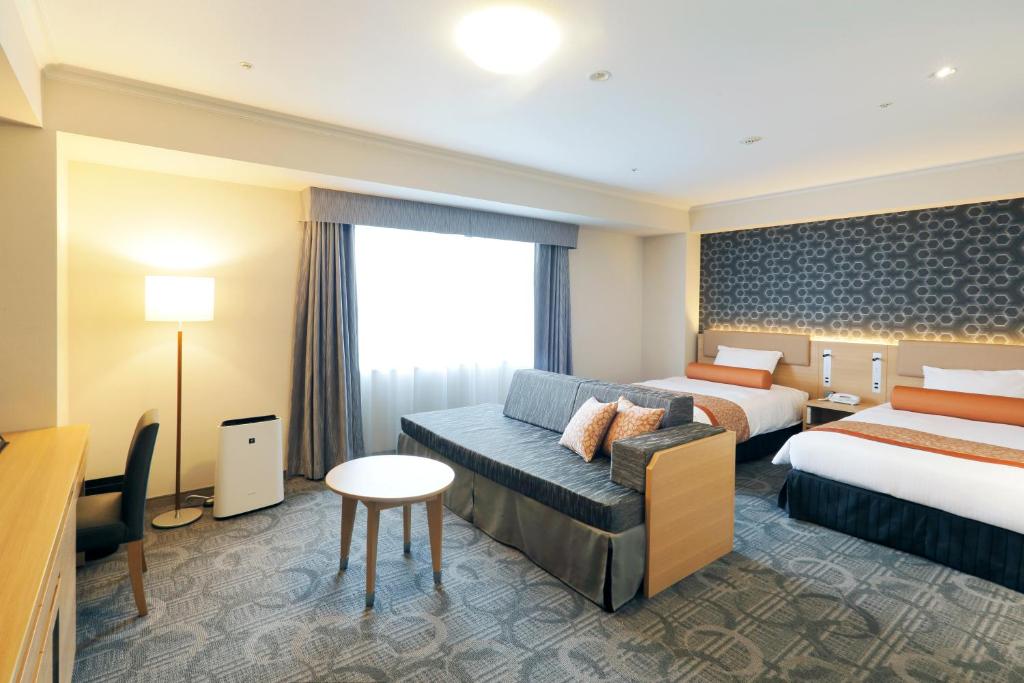 Postel nebo postele na pokoji v ubytování Sapporo Excel Hotel Tokyu