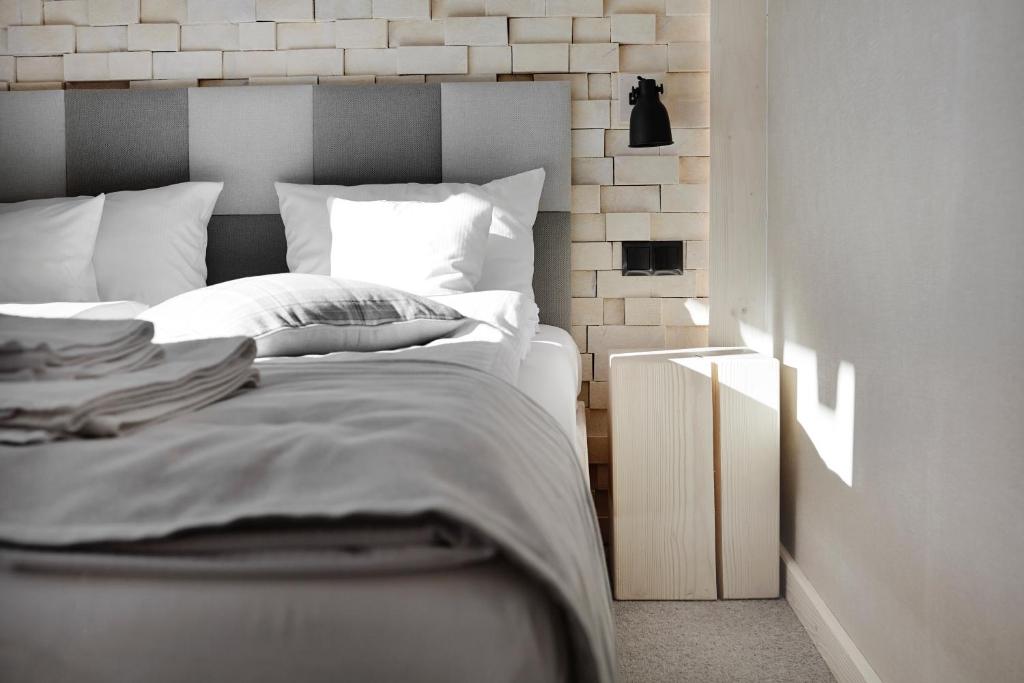 a bedroom with a bed with a brick wall at VILLA NOSAL - Zakopane in Zakopane