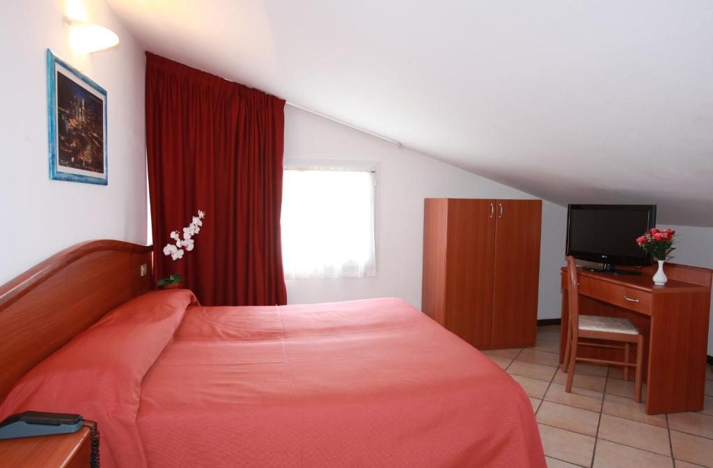 Postel nebo postele na pokoji v ubytování Hotel Storione