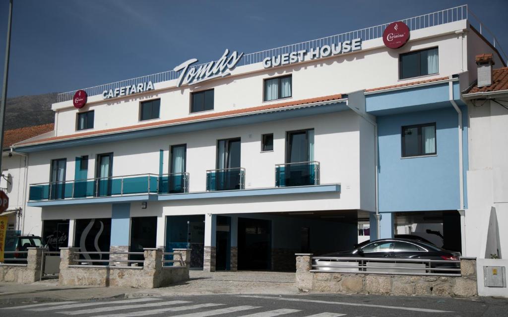 a building with a car parked in front of it at Tomas Guest House II in Covilhã