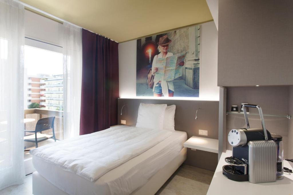 Postel nebo postele na pokoji v ubytování Hotel City Locarno