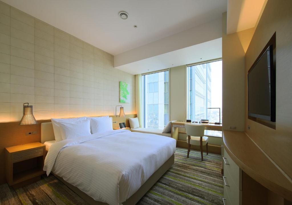 a hotel room with a bed and a television at Nagoya JR Gate Tower Hotel in Nagoya