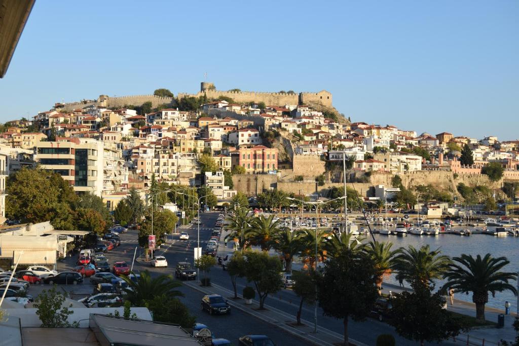 a view of a city with a harbor and buildings at Maria's House in Kavala