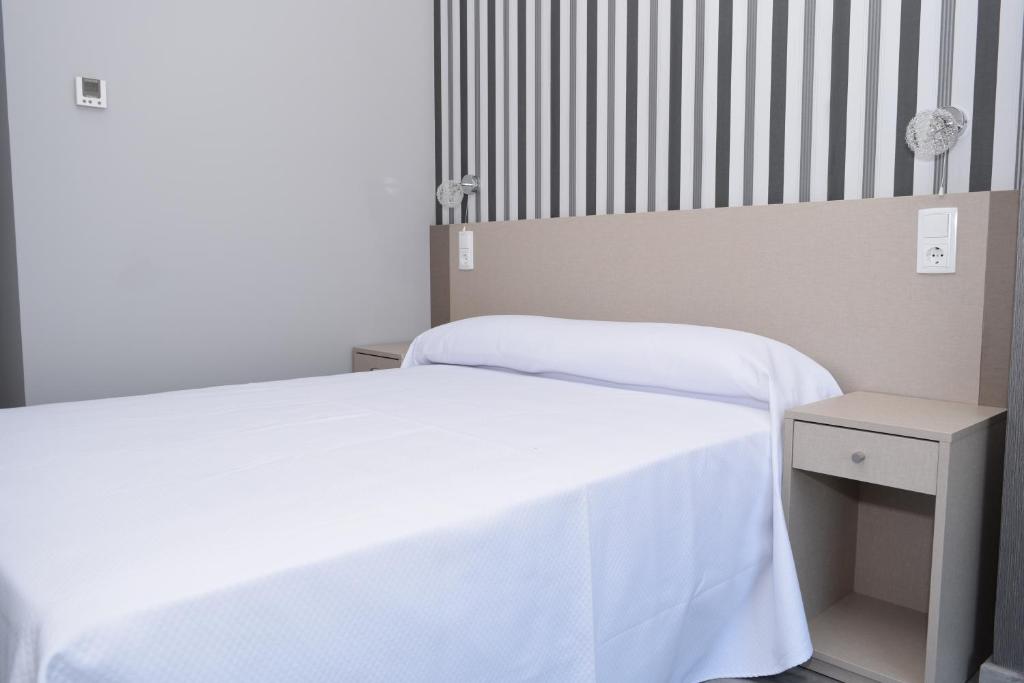 Postel nebo postele na pokoji v ubytování Hotel Siskets