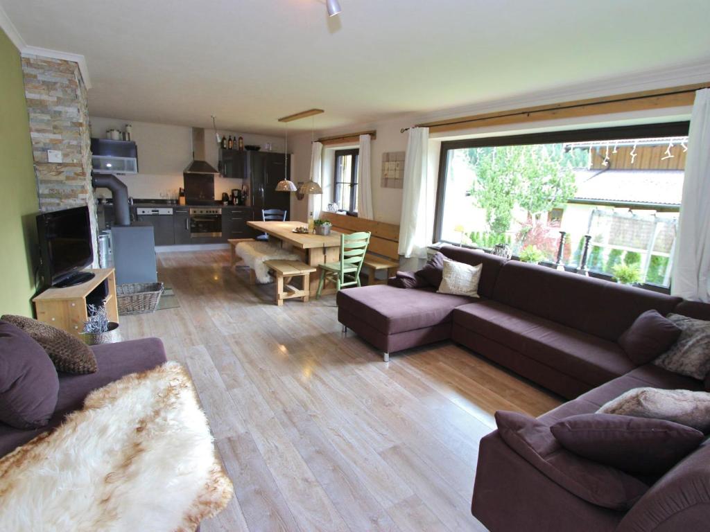 a living room with a couch and a table at Stylish authentic holiday home in Leogang Salzburgerland near ski area in Leogang