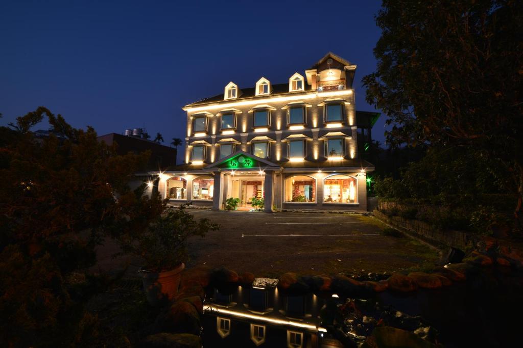 a large building with lights on it at night at Songyuan B&B in Lugu Lake